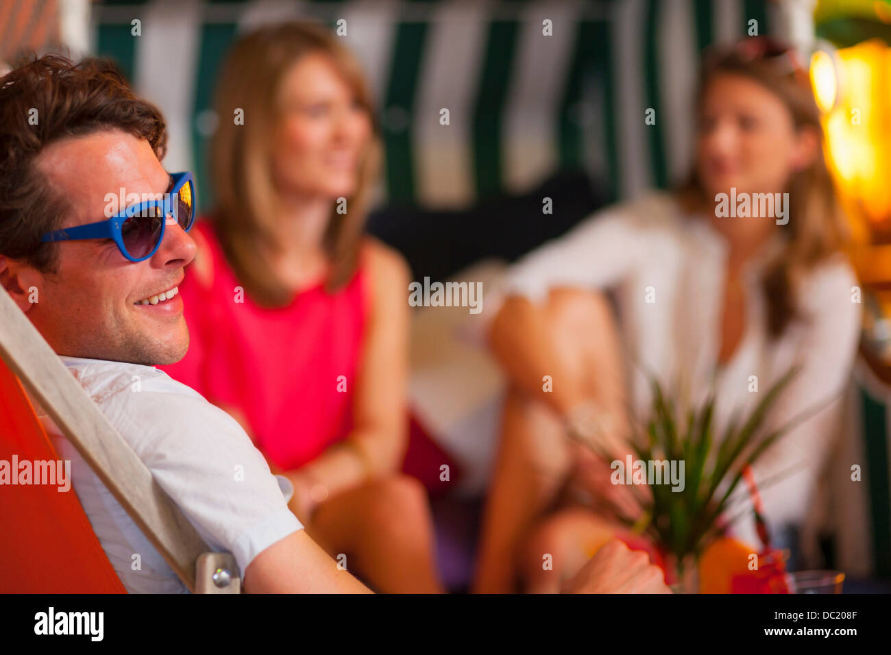 Group of friends enjoying indoor beach party Stock Photo