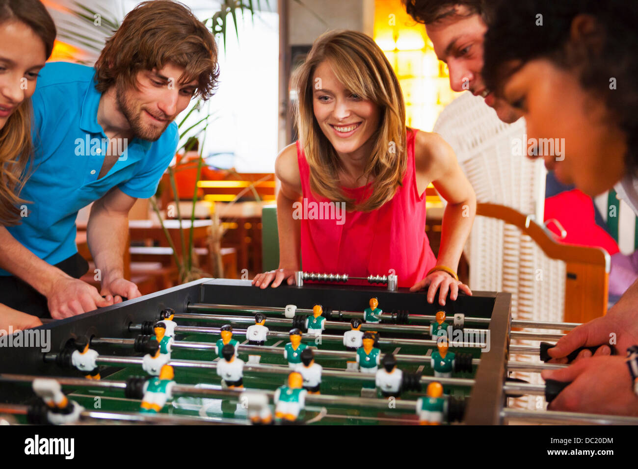 Friends playing table football Stock Photo