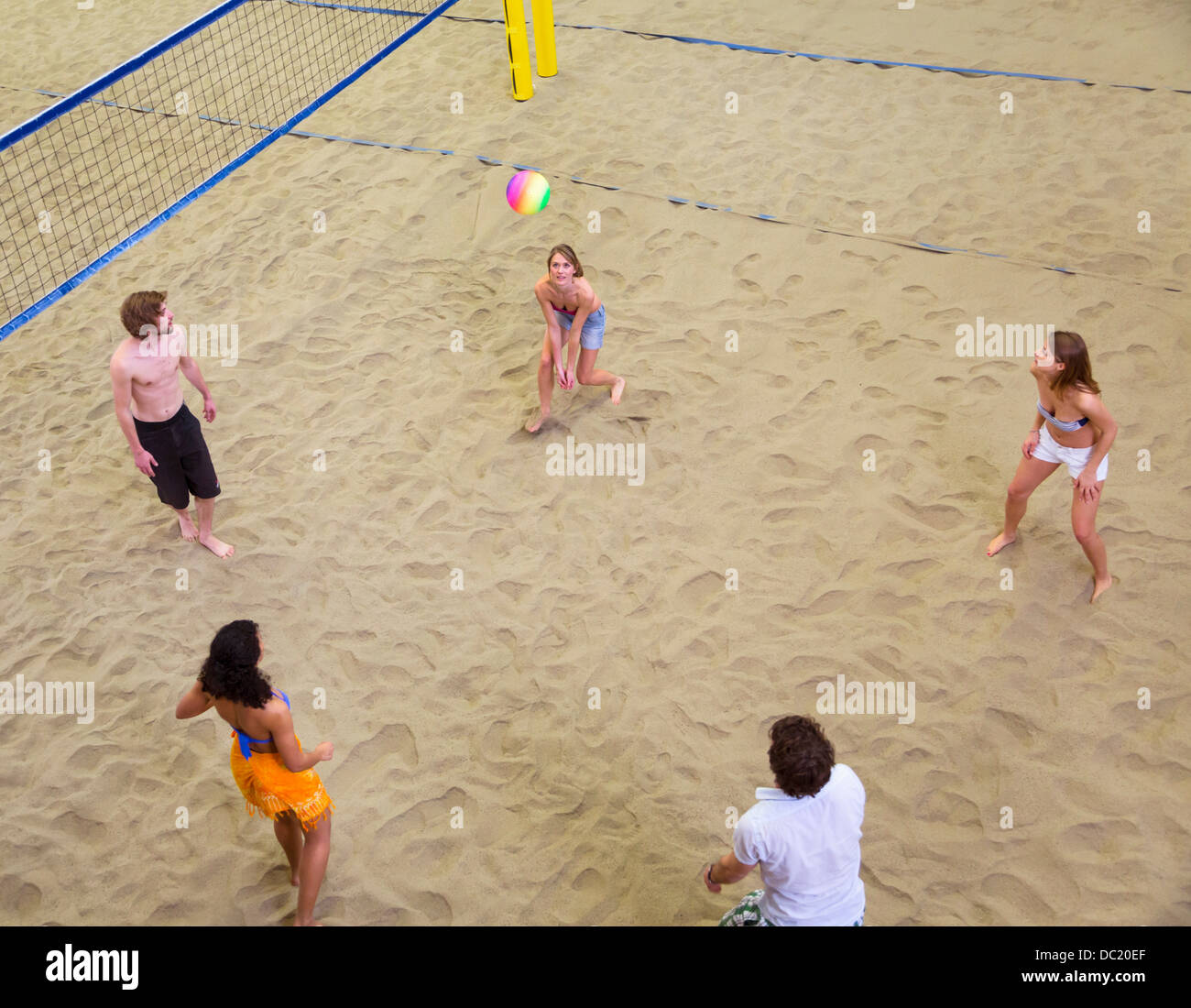 Aerial view of friends playing indoor beach volleyball Stock Photo