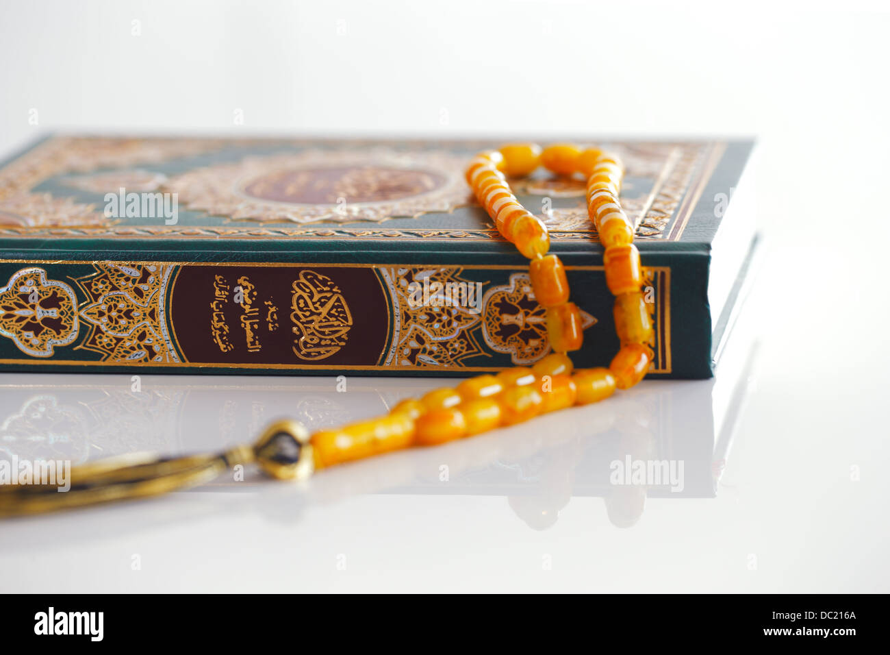 The Masbaha is also known as Tasbih is a string of prayer beads which is traditionally used by Muslims along with the Quran Stock Photo