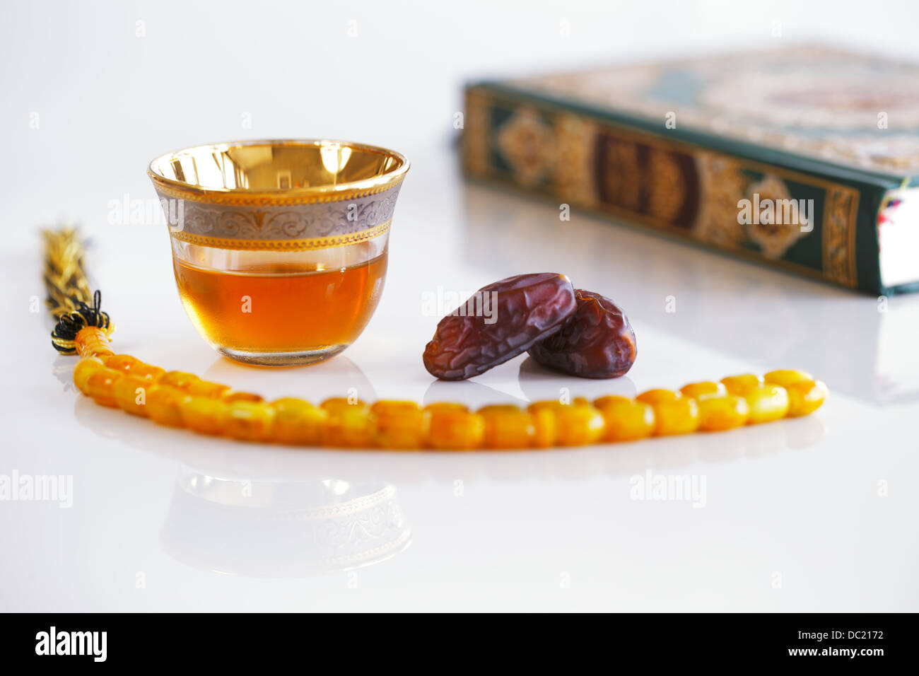 The Masbaha is also known as Tasbih is a string of prayer beads which is traditionally used by Muslims along with the Quran Stock Photo