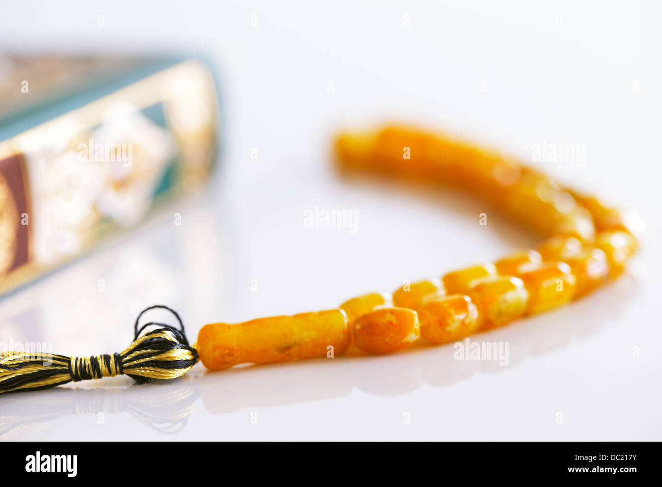 The Masbaha is also known as Tasbih is a string of prayer beads which is traditionally used by Muslims along with the Quran Stock Photo