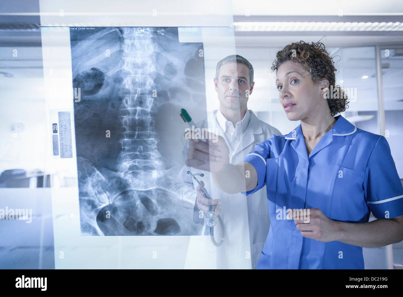 Doctor and nurse looking at xray results displayed on screen Stock Photo