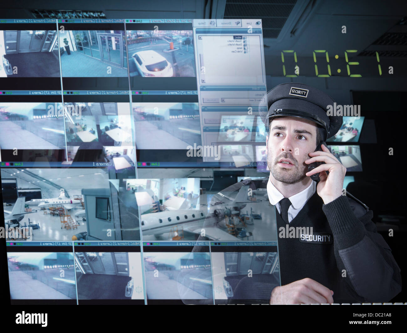 Security guard monitoring camera visuals on interactive screen Stock Photo