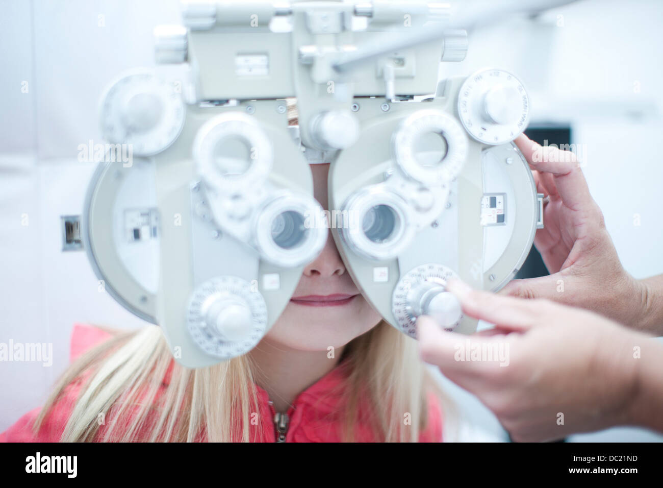 Optician testing young girl in eye clinic Stock Photo