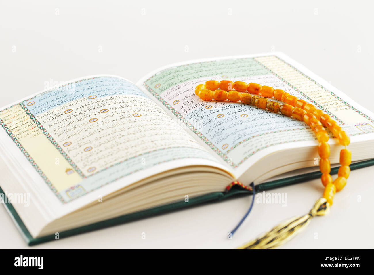 The Masbaha is also known as Tasbih is a string of prayer beads which is traditionally used by Muslims along with the Quran Stock Photo