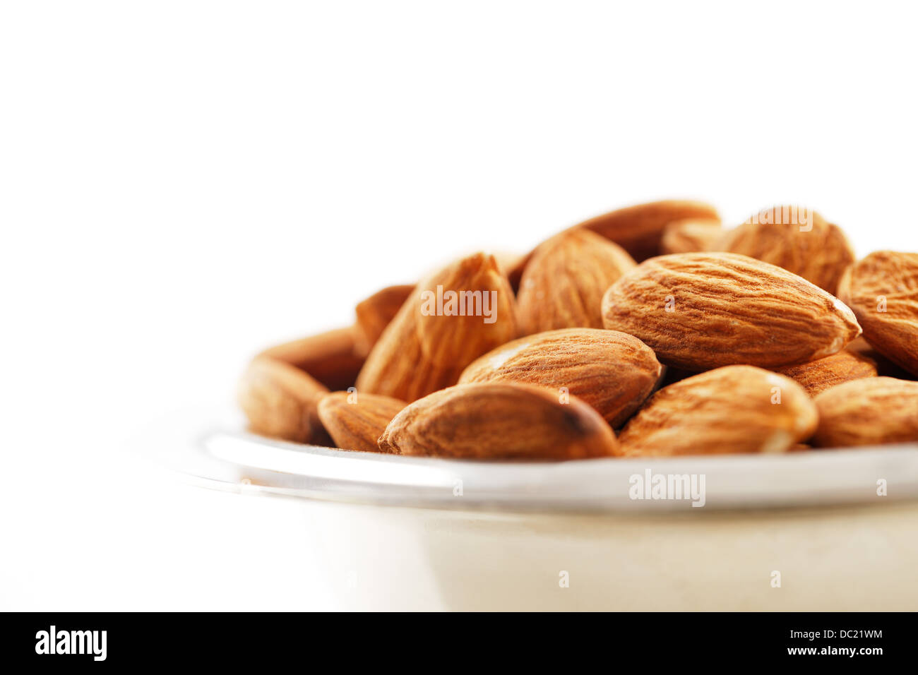 A handful of almonds on a white background Stock Photo Alamy