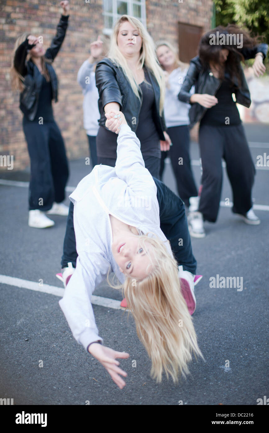 Girls dancing in carpark Stock Photo