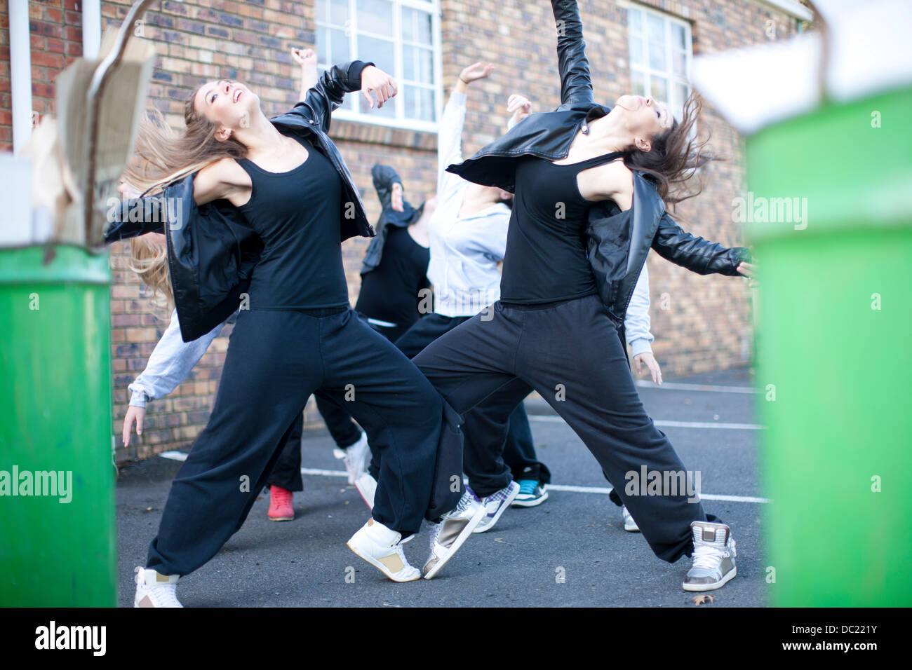 Group of girls dancing in carpark Stock Photo