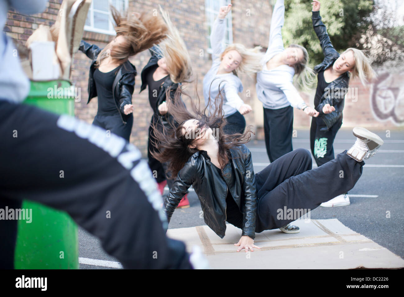 Group of girls breakdancing in carpark Stock Photo