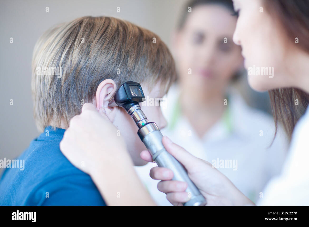 Doctor checking boys ear Stock Photo
