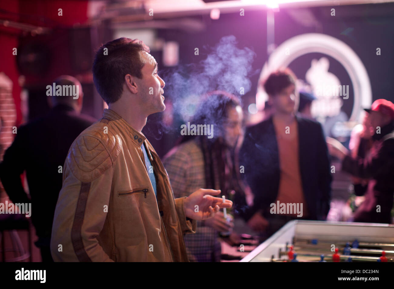 Man smoking cigarette in bar Stock Photo