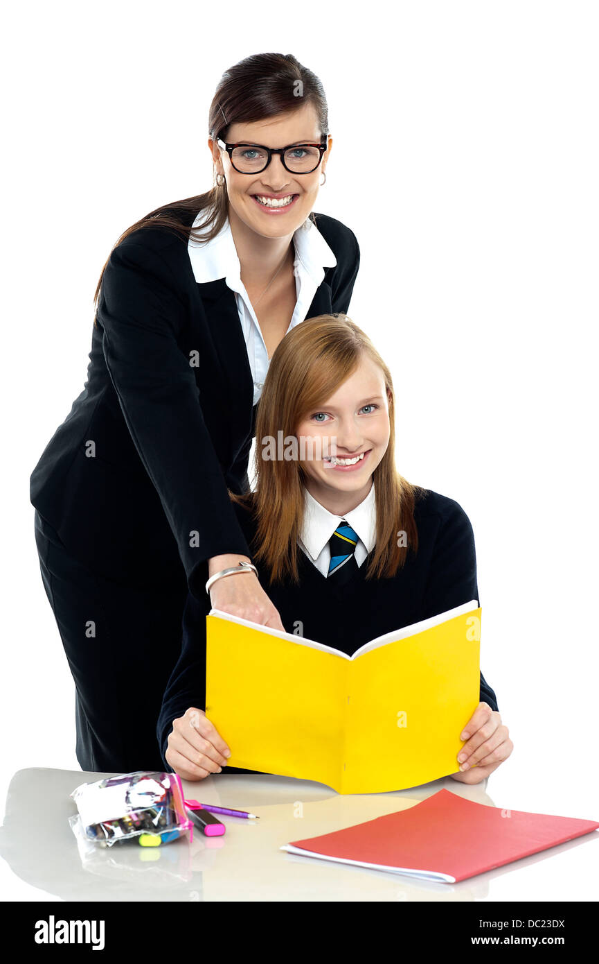 Teacher instructing student and helping her Stock Photo