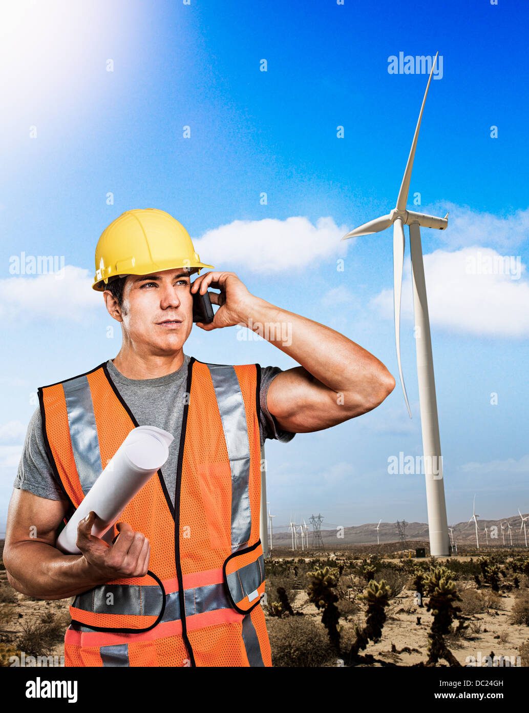 Man standing in front of wind farm Stock Photo