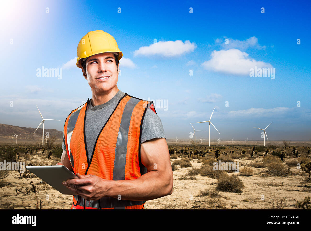 Man standing in front of wind farm Stock Photo