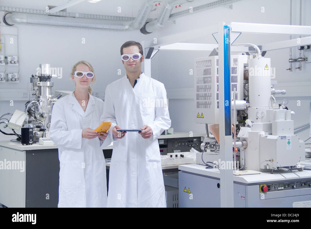 Two scientists wearing lab coats standing in laboratory Stock Photo Alamy