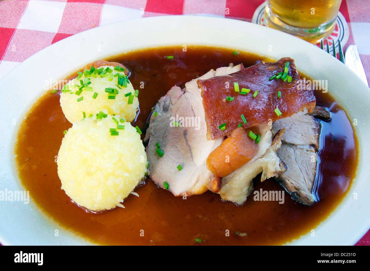 Roast pork with potato dumplings is a popular dish in Bavaria, especially in a beer garden. Stock Photo