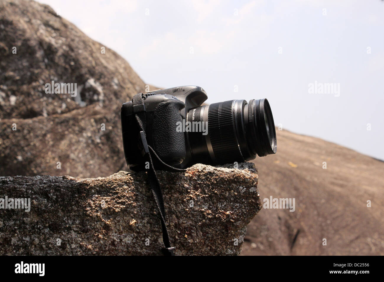 Canon EOS 550D or Rebel T2i  camera placed on a rock Stock Photo
