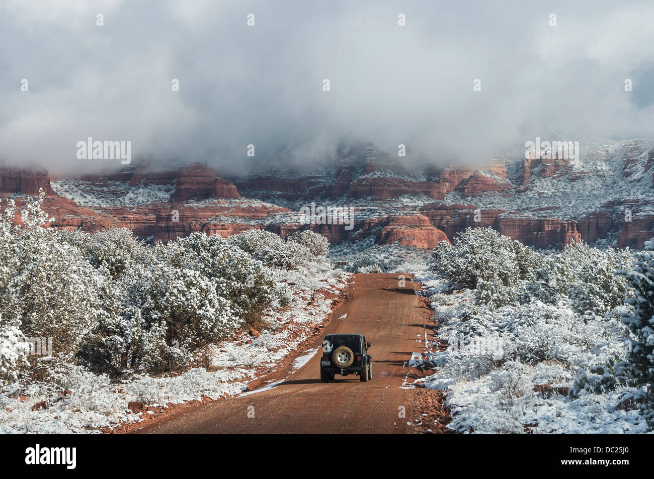 Jeep driving into the backcountry after a snowfall. Sedona, AZ Stock Photo