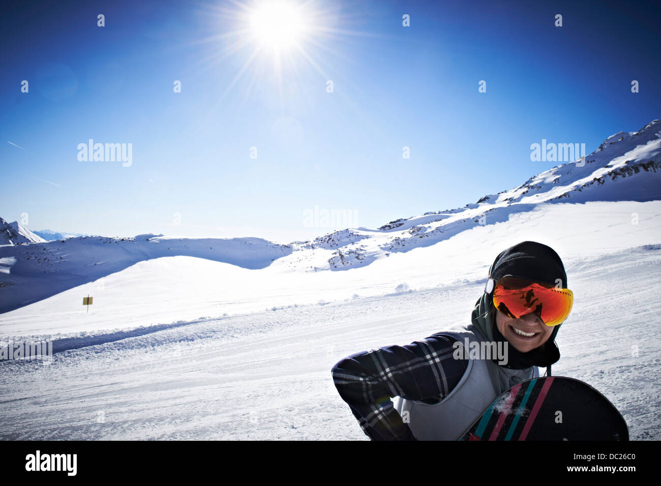 Woman wearing skiwear at top of mountain Stock Photo