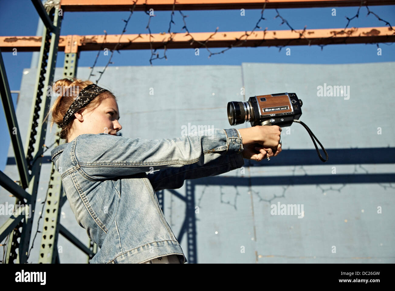 Woman using old video camera to take self portrait Stock Photo