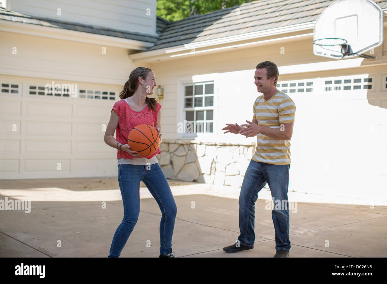Brother and sister playing basketball Stock Photo