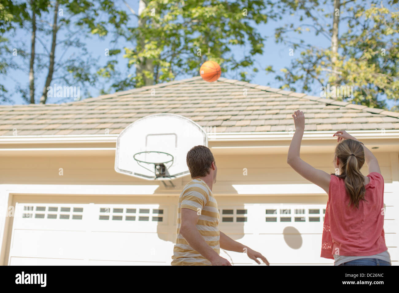 Brother and sister playing basketball Stock Photo Alamy