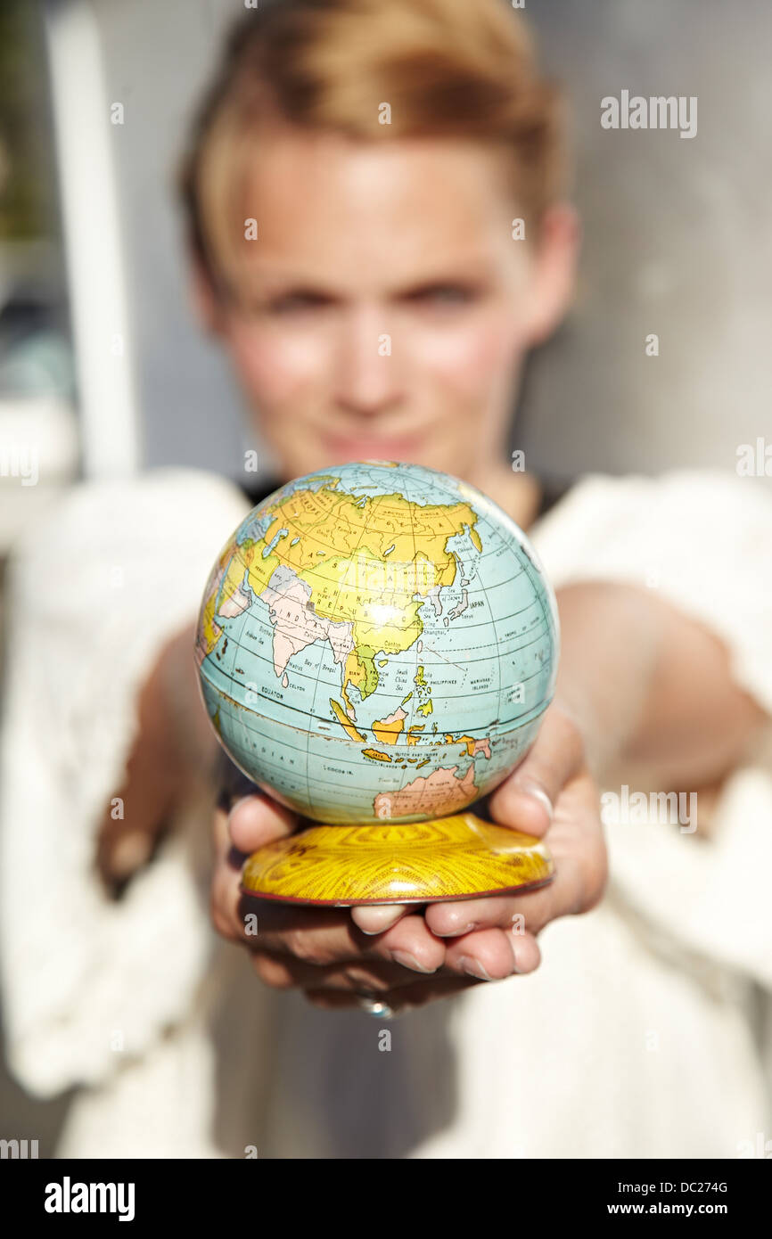 Woman holding globe Stock Photo
