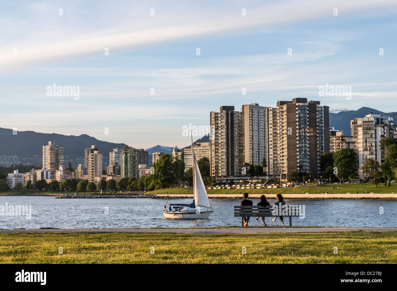 People relaxing on a bench at Kits Beach, Vancouver, BC, Canada. Stock Photo