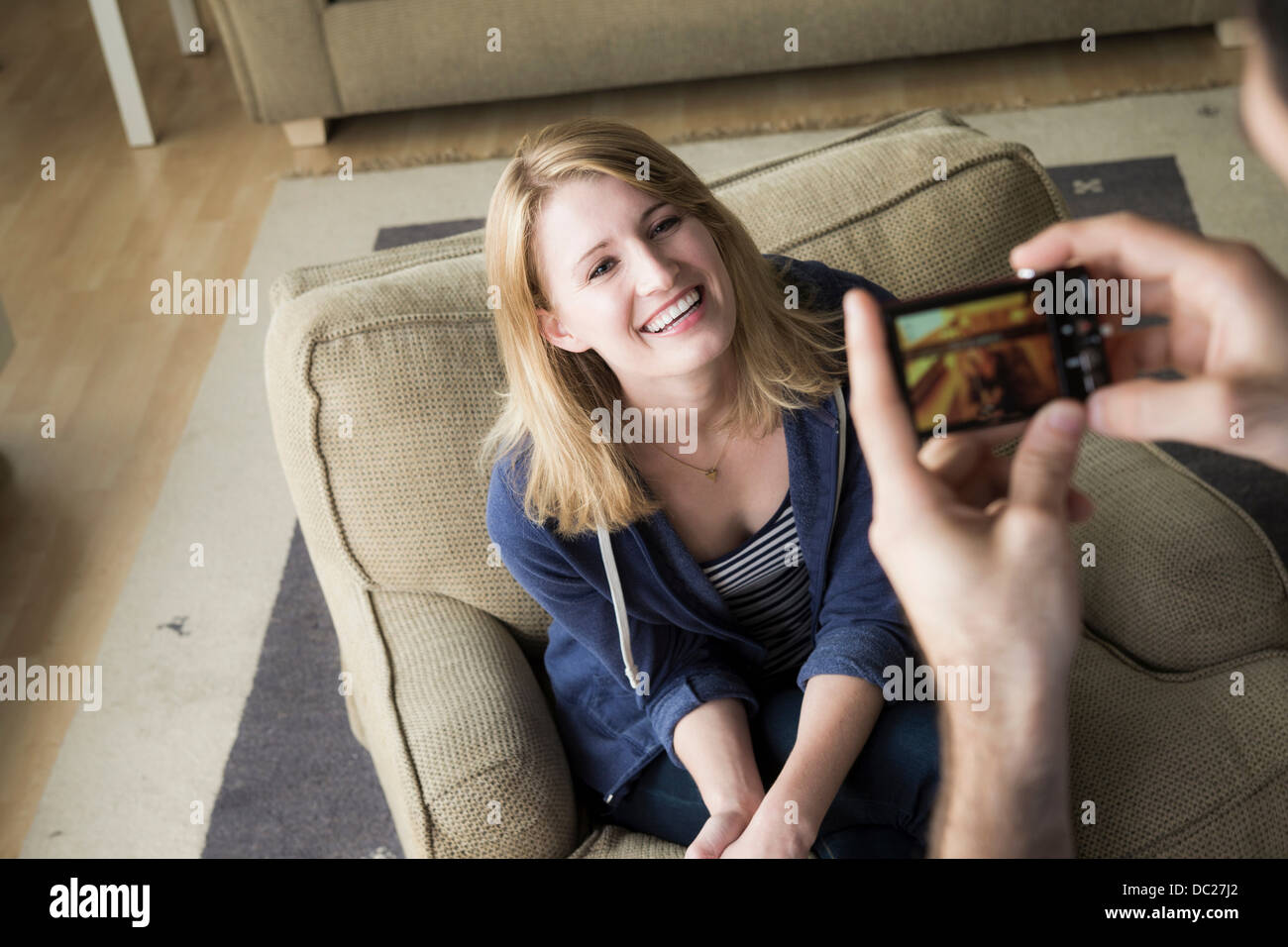 Man photographing young woman on cell phone Stock Photo