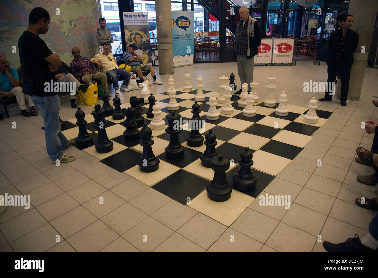 People playing chess with a giant board and pieces in the central library Rotterdam Netherlands Stock Photo