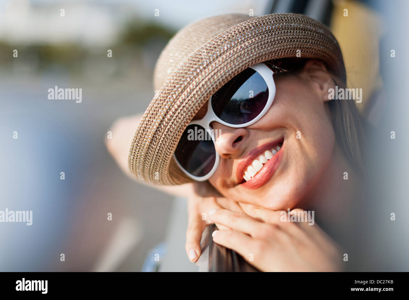 Mature woman wearing sunglasses and sunhat Stock Photo