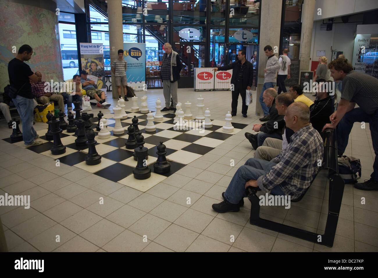 People playing chess with a giant board and pieces in the central library Rotterdam Netherlands Stock Photo