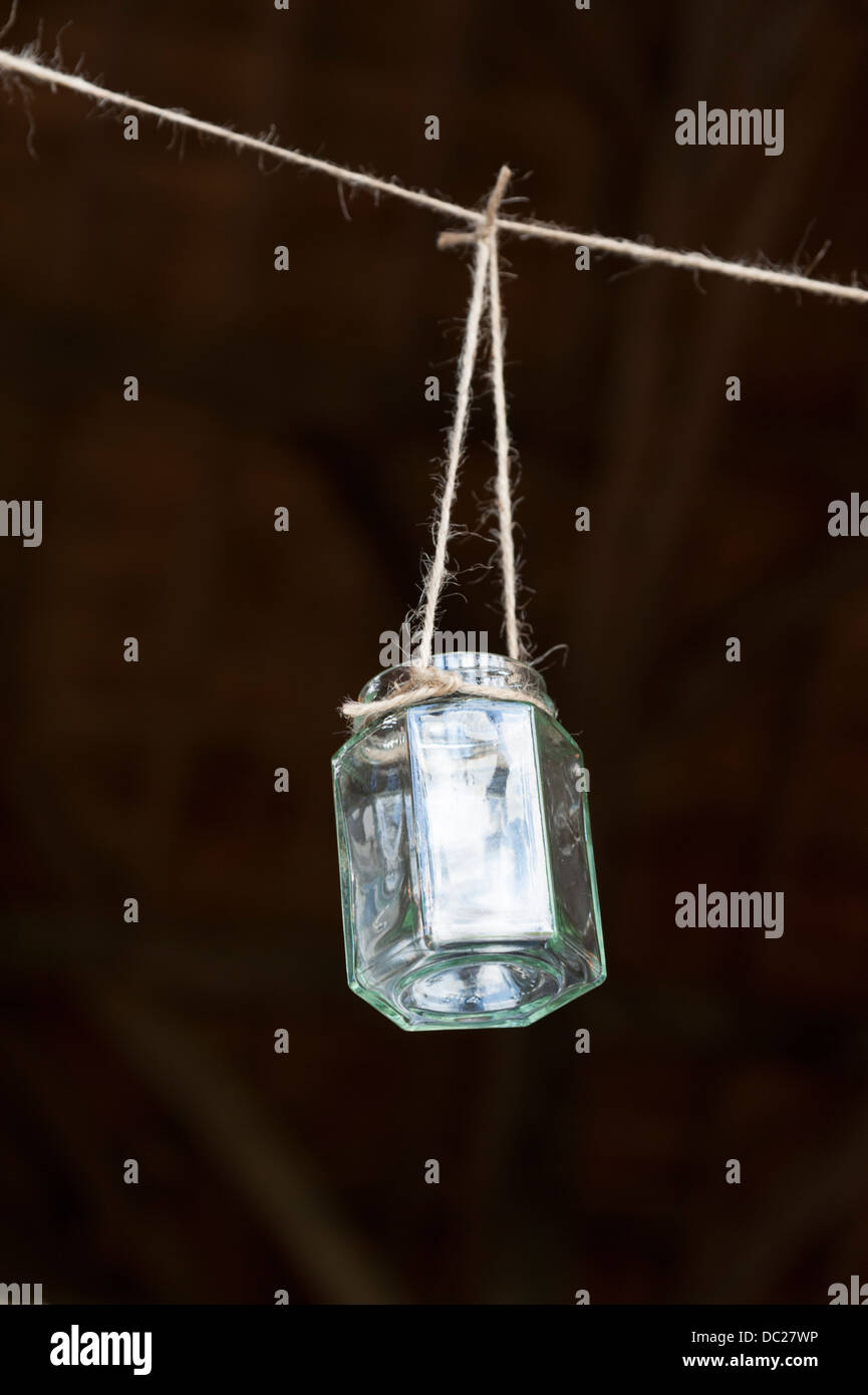 A jam jar hanging by string as a homemade decoration Stock Photo Alamy