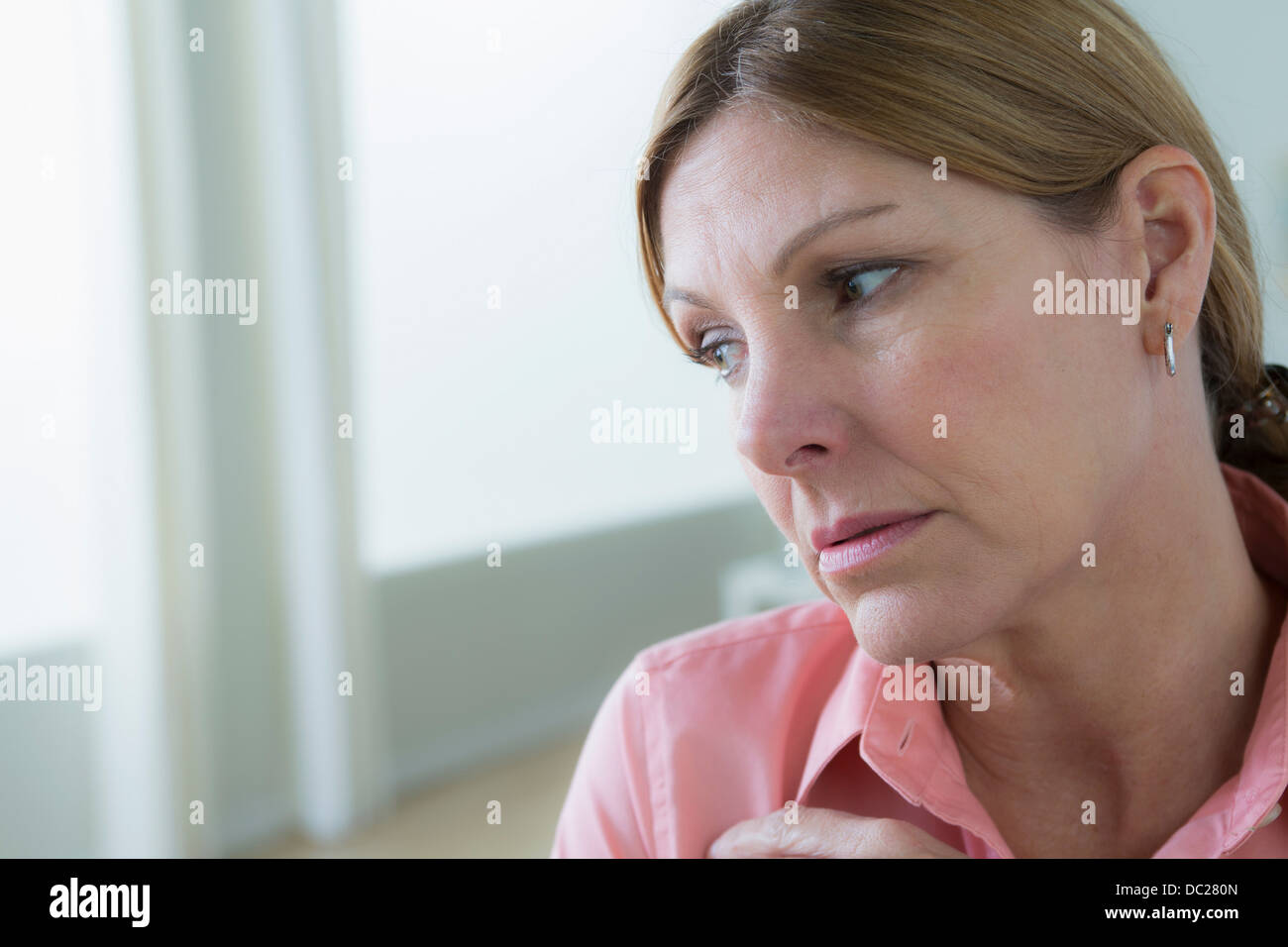 Portrait of sad mature woman looking away Stock Photo