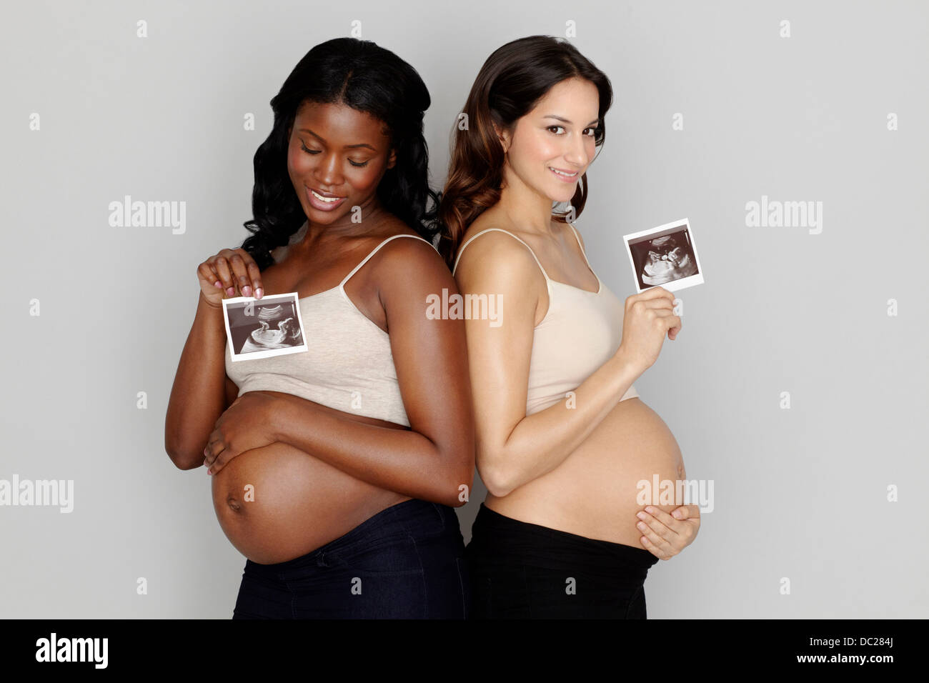 Two pregnant women holding ultrasound scans Stock Photo
