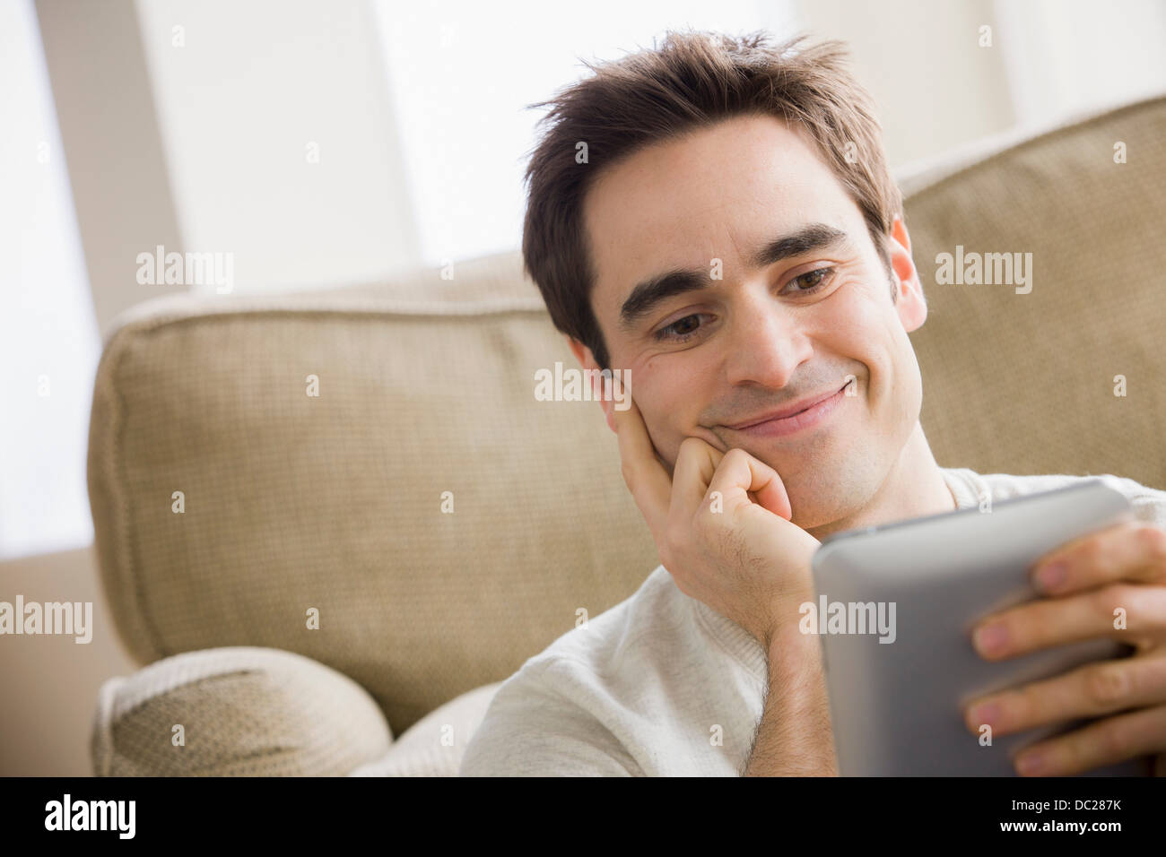 Mid adult man holding electronic reader Stock Photo