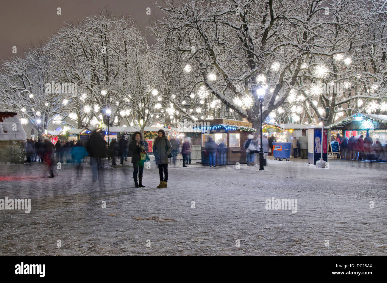 Switzerland, Basel. Munsterplatz Winter Holiday Market. Holiday lights on a winter night at the Musterplatz market. Stock Photo