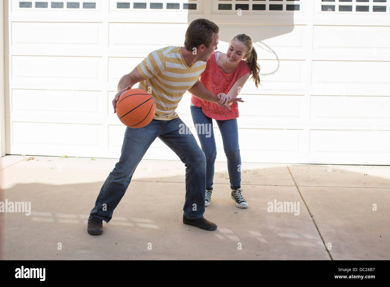 Brother and sister playing basketball Stock Photo Alamy