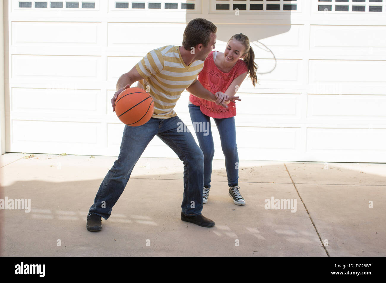 Brother and sister playing basketball Stock Photo - Alamy