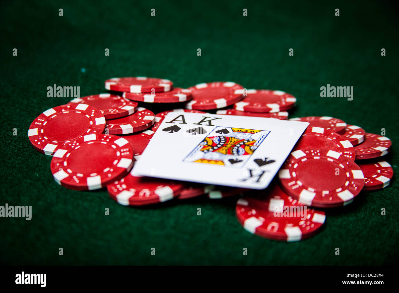 Ace and king of spades on red poker chips Stock Photo Alamy