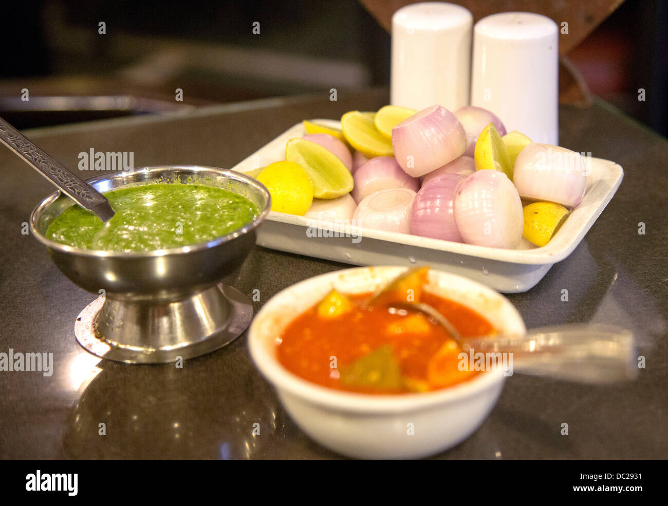 Curry house condiments India lime pickle onions and mint sauce Stock Photo