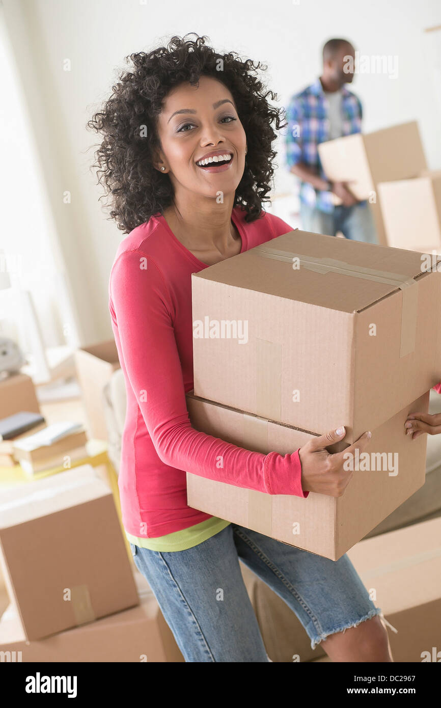 Woman Carrying Heavy Boxes High Resolution Stock Photography and Images