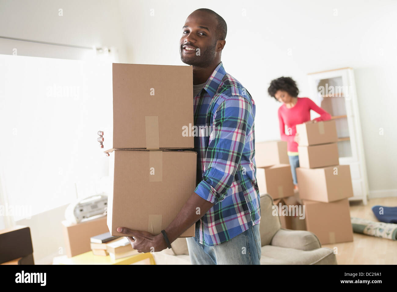 Mid adult man carrying cardboard boxes Stock Photo