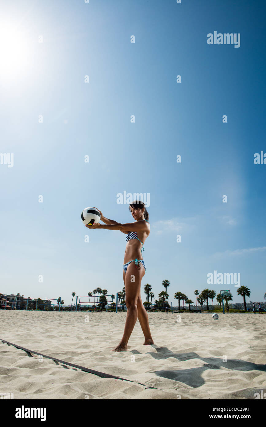 mature-woman-serving-in-beach-volleyball-stock-photo-alamy