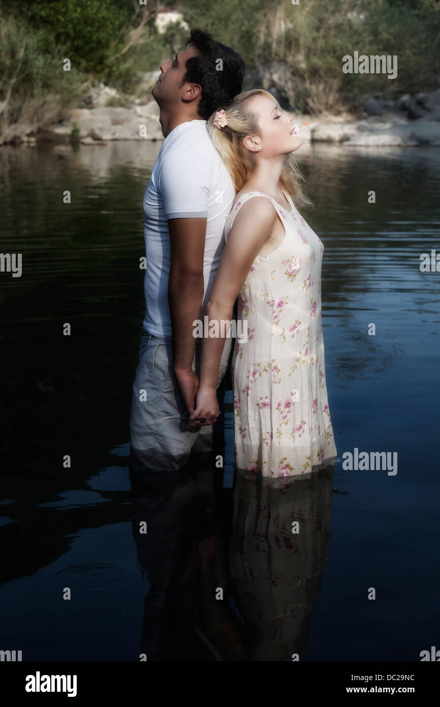 a couple in water, back to back Stock Photo