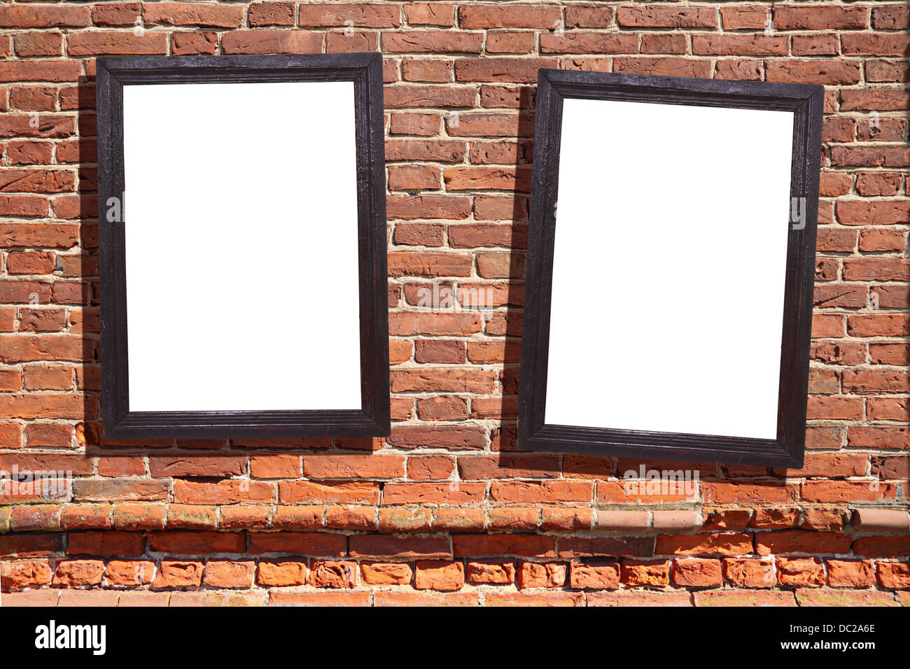 Two vintage wooden framework on antique wall from brown brick Stock Photo