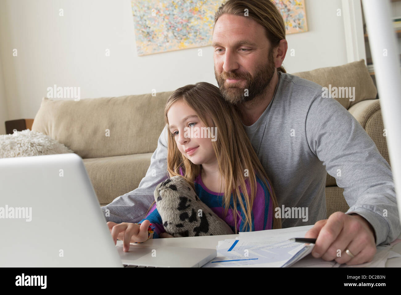 Father with child using laptop Stock Photo - Alamy