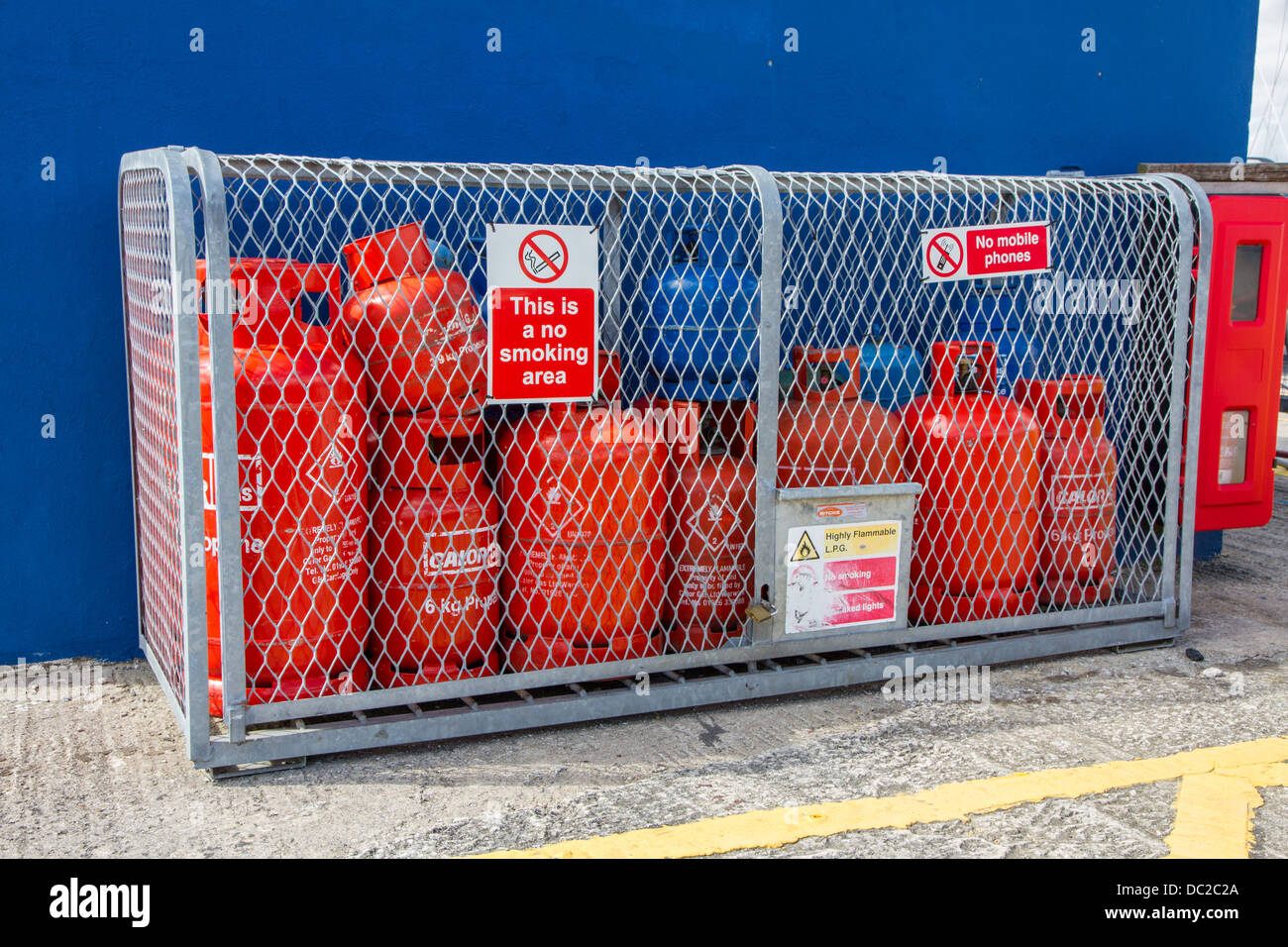 Gas bottles being stored in a cage with no smoking sign Stock Photo Alamy