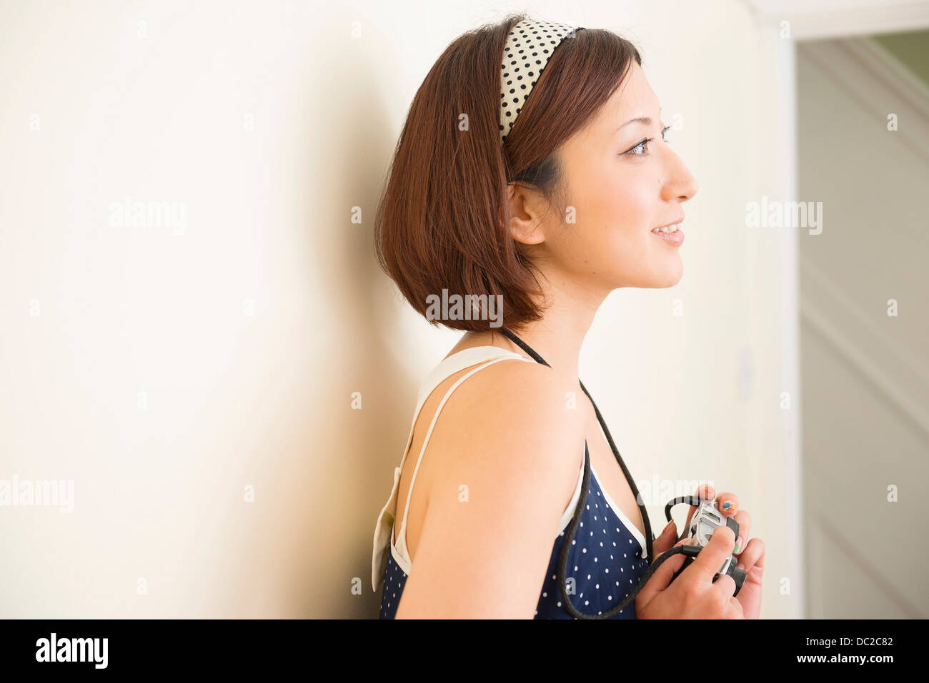 Woman with camera looking into distance Stock Photo